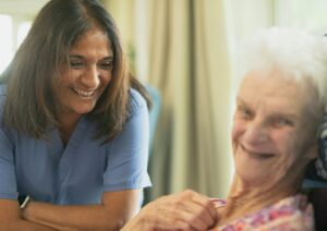Nurse smiling with an elderly patient at home, illustrating home oxygen therapy care